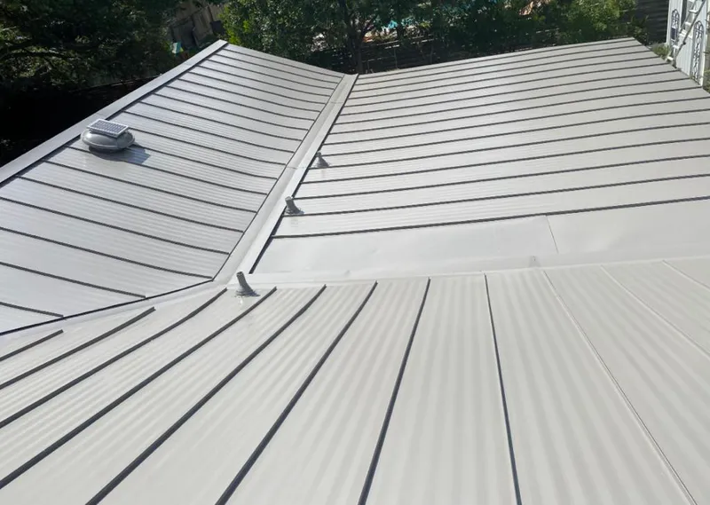 Solar attic fan installed on a metal roof for Roof Ventilation in St. Peter